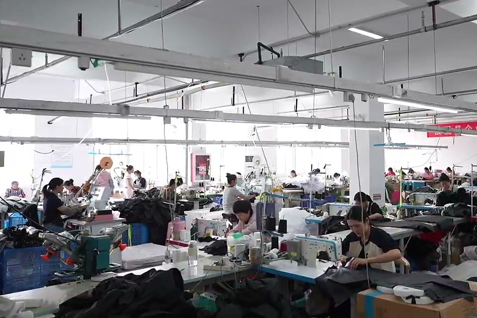 MOTOSINOLL production floor in Suining, Xuzhou — cutting, sewing and seam sealing under one roof