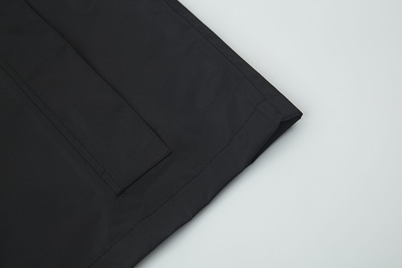 Pocket flap stitching detail on black face fabric