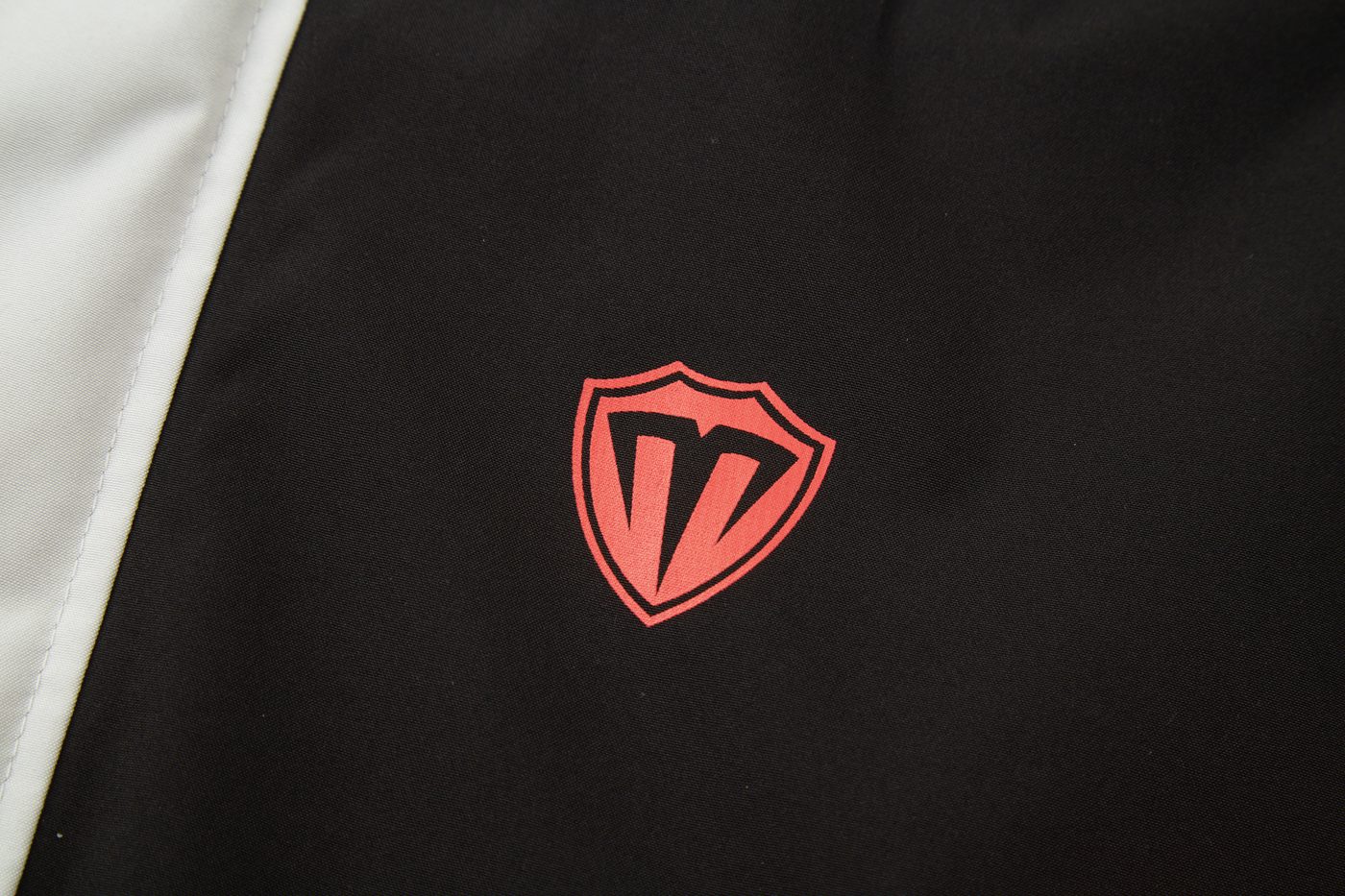 Reflective red shield logo print on chest — macro