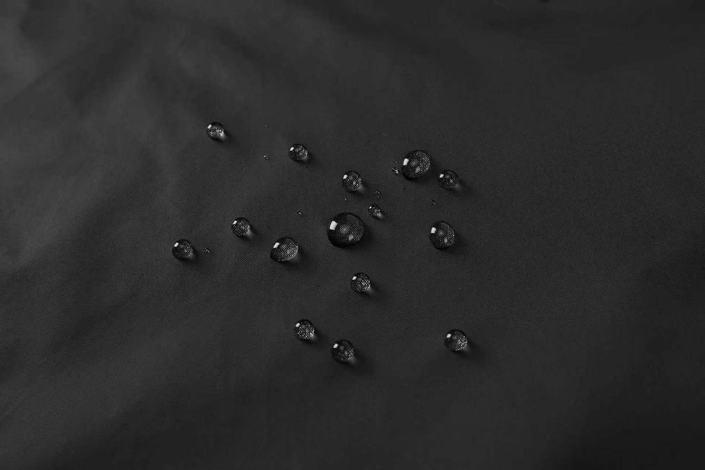 DWR water beading on the 210T Nylon Taffeta face fabric — water sits on the surface as beads and rolls off