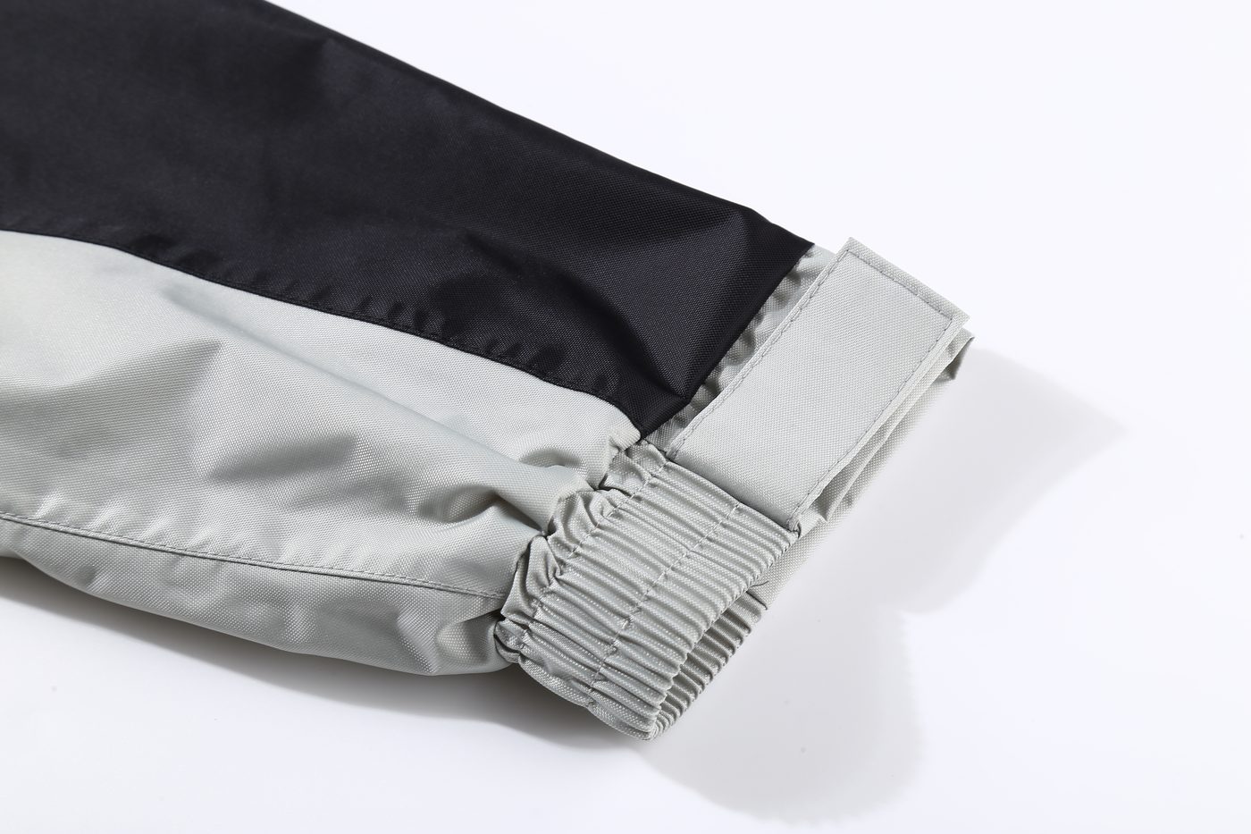 Elasticated inner sleeve cuff with hook-and-loop adjuster on grey