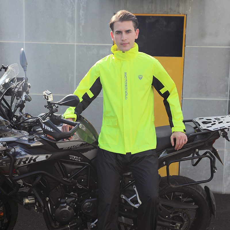 Rider wearing SN-112 Fluoro Yellow jacket next to an adventure motorcycle