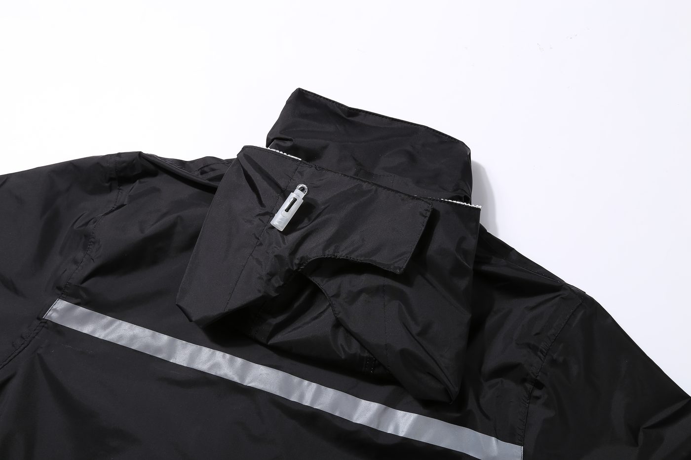 Hood stowed under collar with back reflective band visible