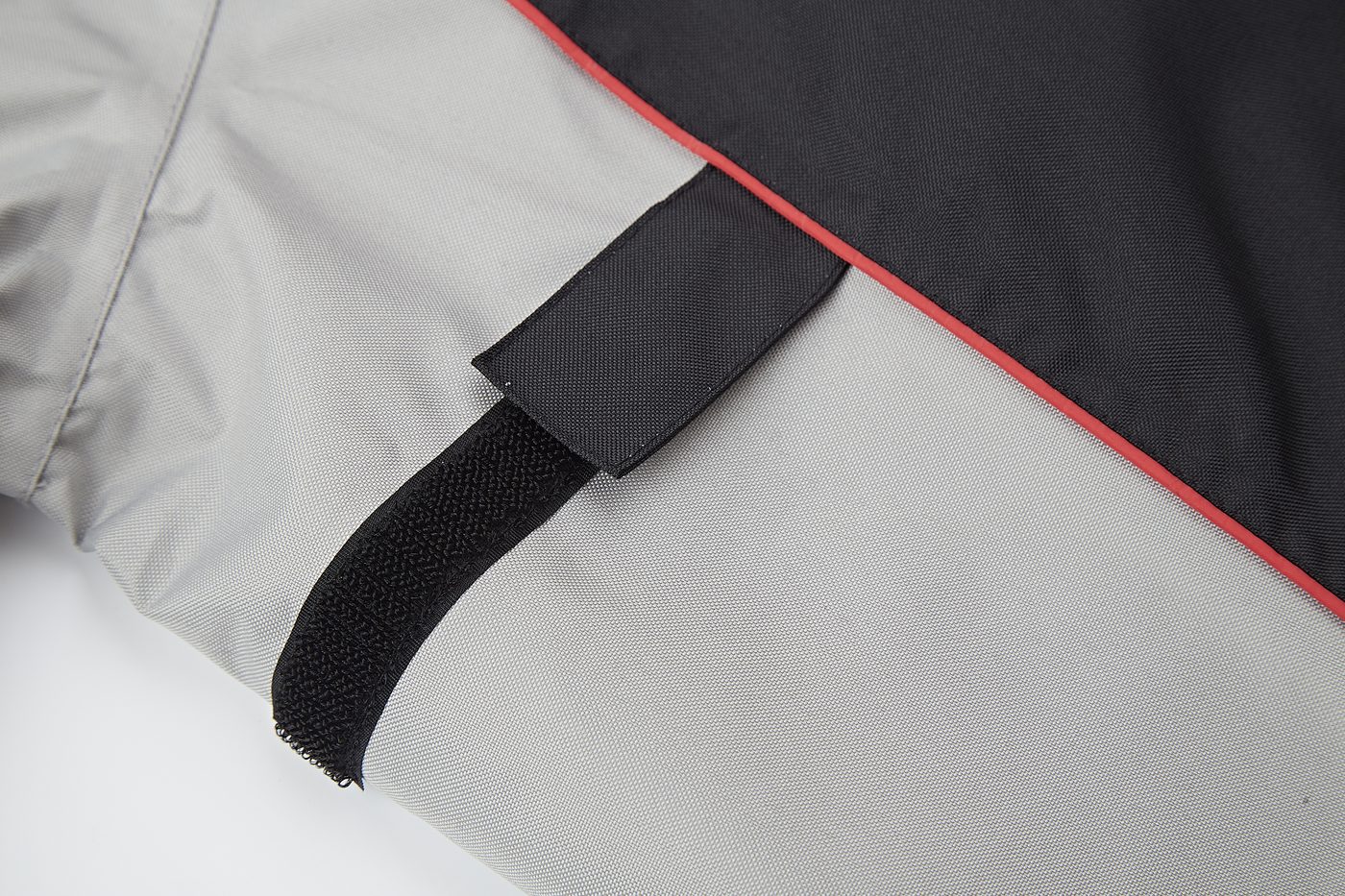 Sleeve cuff with reflective trim and hook-and-loop adjuster