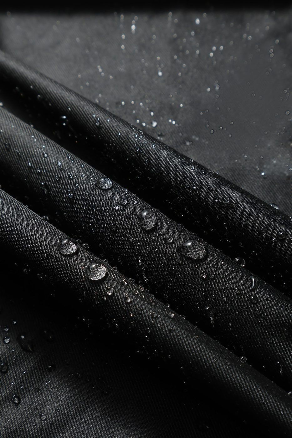 DWR water beading on the 300D Oxford face fabric — water beads sit on the surface and roll off